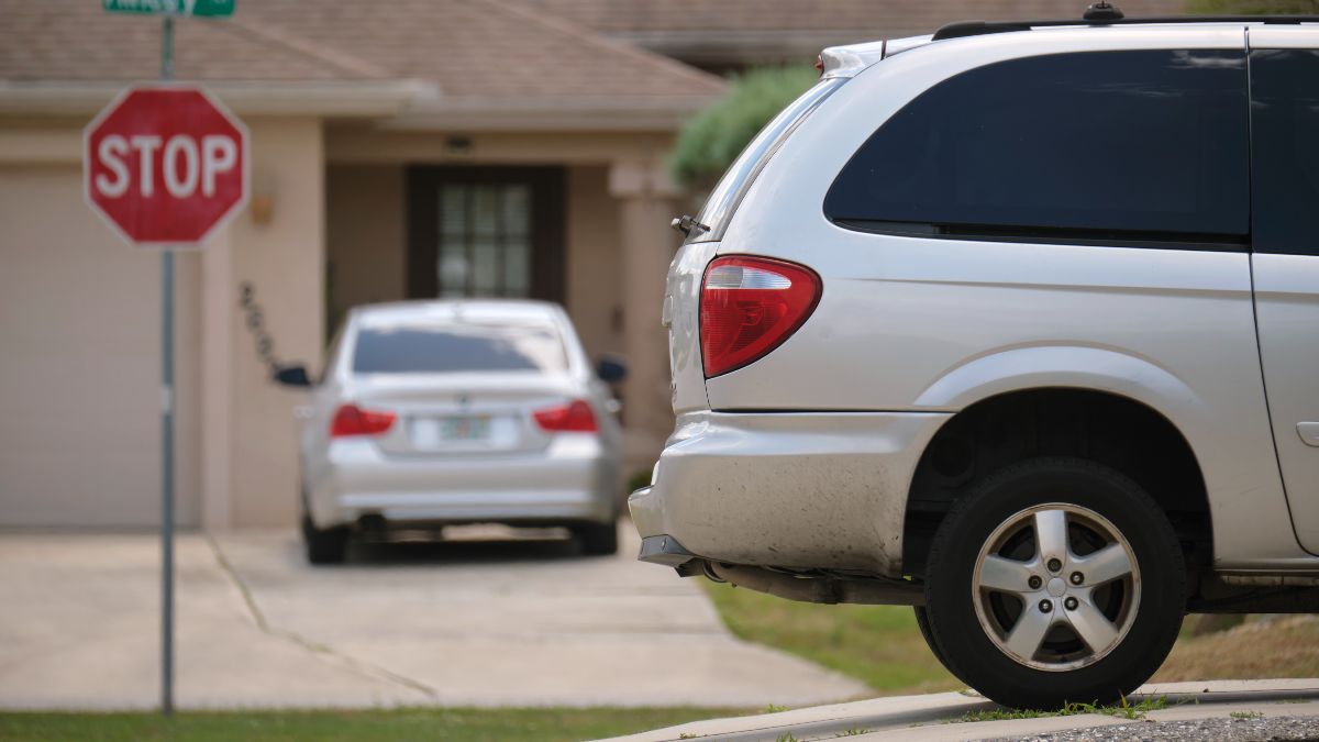 He parks in the driveway of his house for 10 minutes to eat and is fined because he was trespassing on the sidewalk